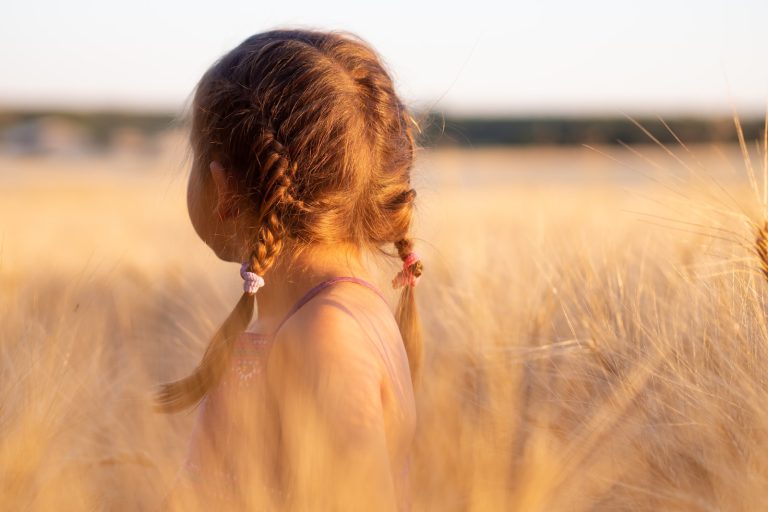 girl wearing pink camisole on brown plant during daytime